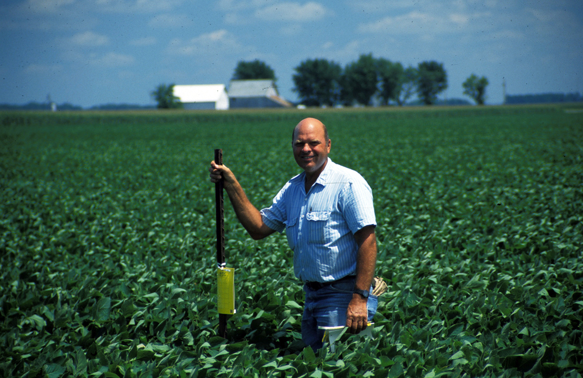 A happy, and informed, producer changing out sticky traps. (Photo Credit: John Obermeyer)
