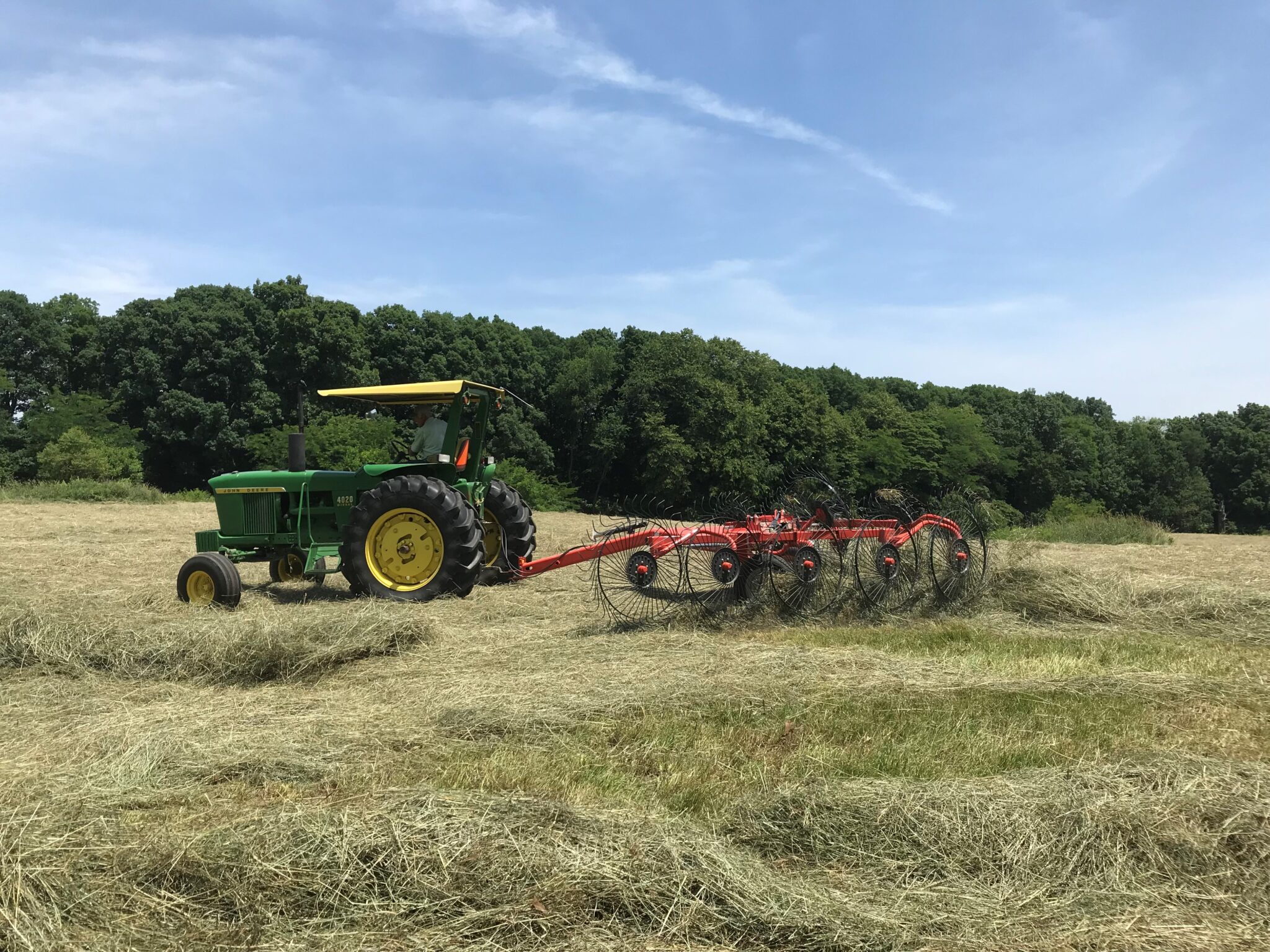 Raking hay into a windrow before baling occurs. (Photo Credit: Keith Johnson)