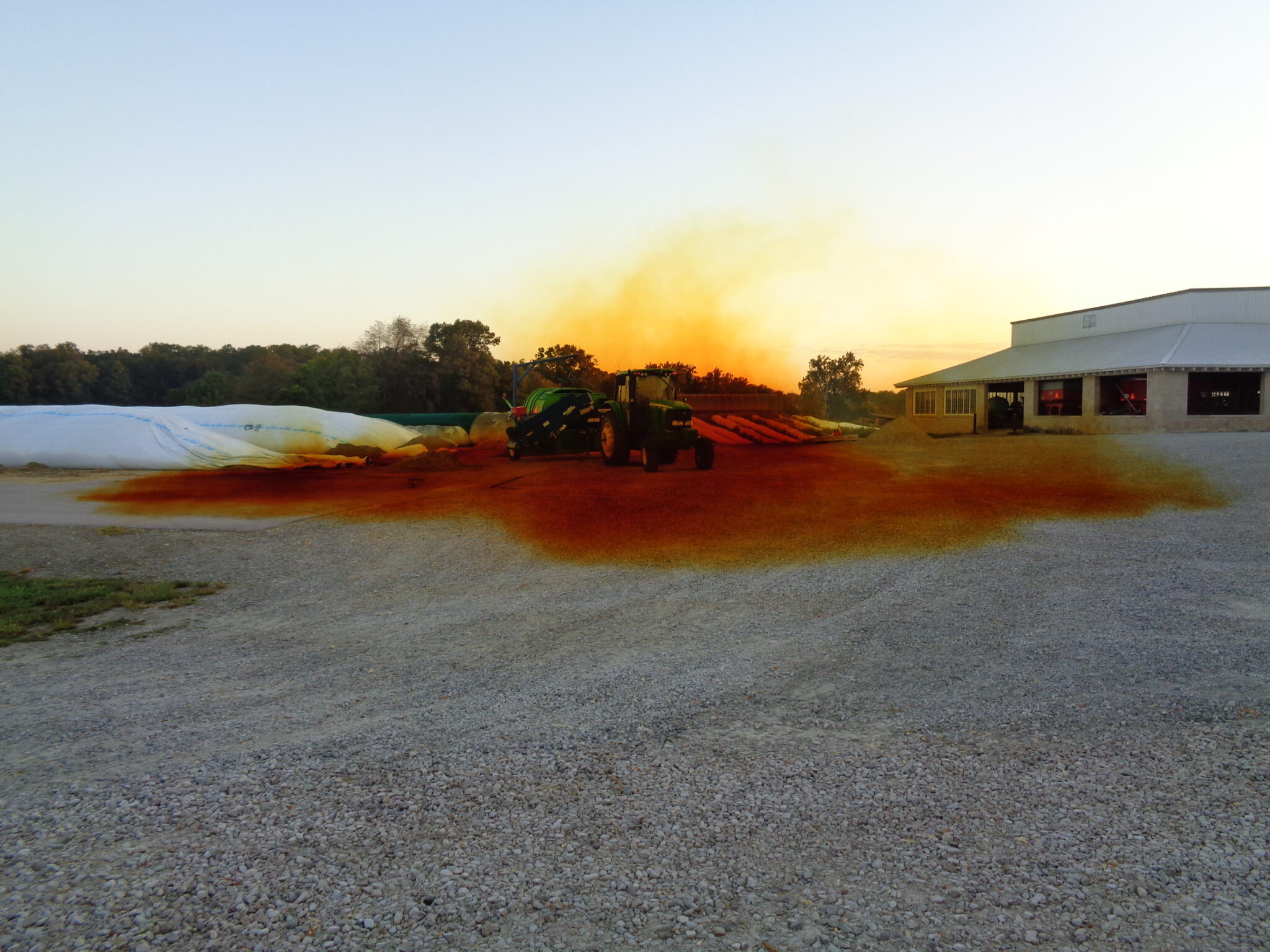 The orange, heavy, and poisonous gas, nitrogen tetroxide, flows out the end of a silage bag filled with corn chopped and bagged the previous day.